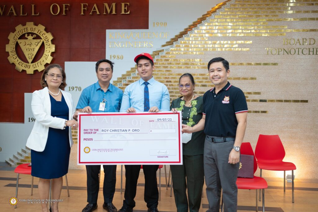 MELE FIRST PLACER receiving his cash award with four other persons